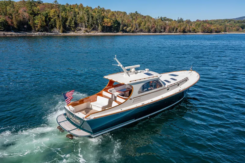 Slide: The Image of 2002 Hinckley Talaria 44 Express yacht cruising on a scenic lake. - 18