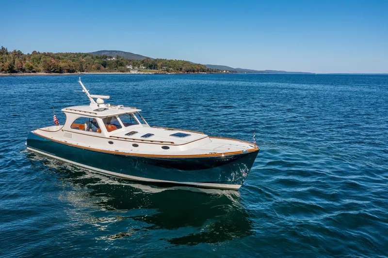 Slide: The Image of 2002 Hinckley Talaria 44 Express yacht cruising on a serene blue sea. - 2