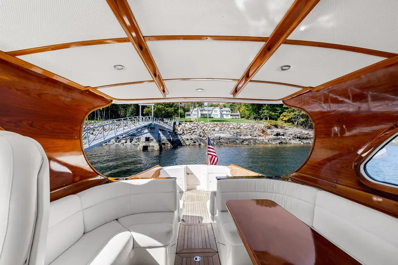 Slide: The Image of Hinckley Talaria 44 Express 2002 yacht interior with elegant wood finish and waterfront view. - 23