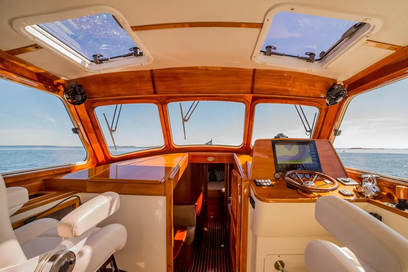 Slide: The Image of Interior of 2002 Hinckley Talaria 44 Express yacht with wooden dashboard and ocean view. - 24