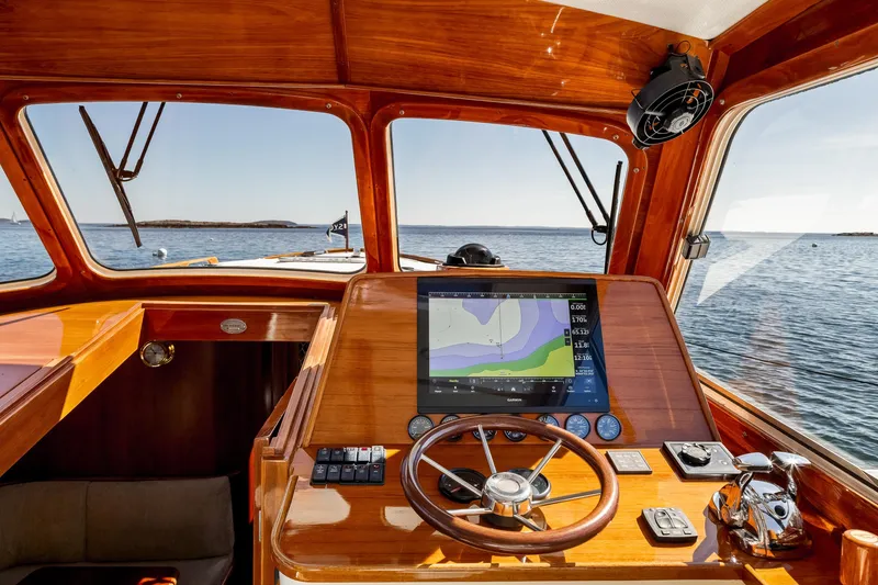 Slide: The Image of Helm of 2002 Hinckley Talaria 44 Express yacht with navigation display, wooden finish, and ocean view. - 27