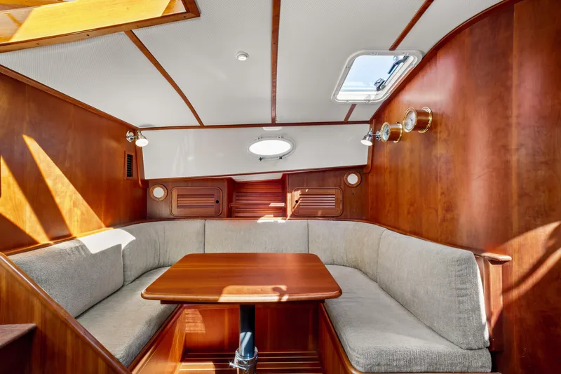 Slide: The Image of Interior of 2002 Hinckley Talaria 44 Express with wooden paneling and cozy seating area. - 32