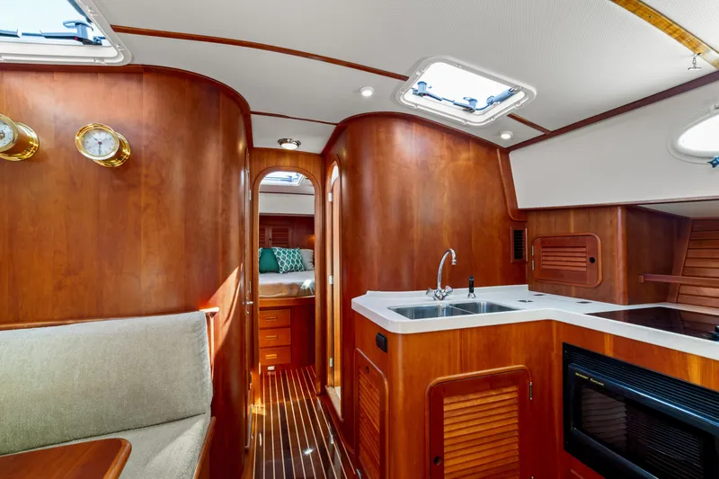 Slide: The Image of Luxurious 2002 Hinckley Talaria 44 Express yacht interior with wood finish and modern amenities. - 37