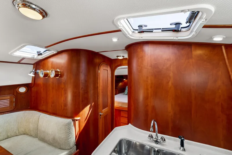 Slide: The Image of Luxurious 2002 Hinckley Talaria 44 Express yacht interior with wood finish and skylight. - 38