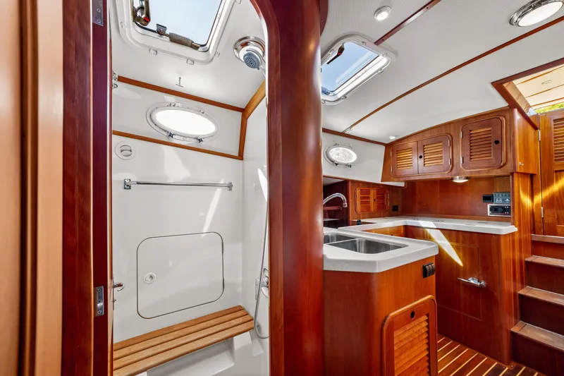 Slide: The Image of Interior of 2002 Hinckley Talaria 44 Express yacht with wooden cabinetry and modern fixtures. - 49