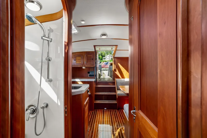 Slide: The Image of Interior of 2002 Hinckley Talaria 44 Express yacht, featuring wooden cabinetry and a shower. - 51