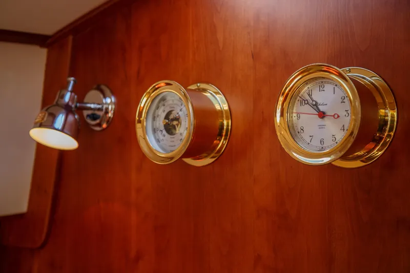 Slide: The Image of Wall-mounted clock and barometer on Hinckley Talaria 44 Express, 2002 model, with wooden paneling. - 52