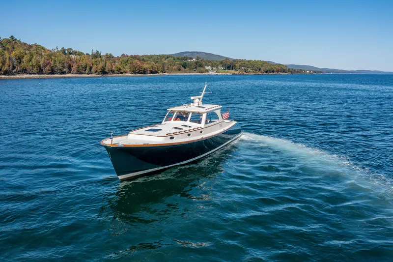 Slide: The Image of Hinckley Talaria 44 Express 2002 cruising on a scenic blue lake. - 6