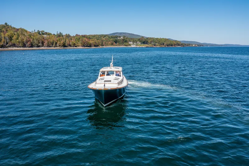 Slide: The Image of 2002 Hinckley Talaria 44 Express cruising on a scenic lake. - 8