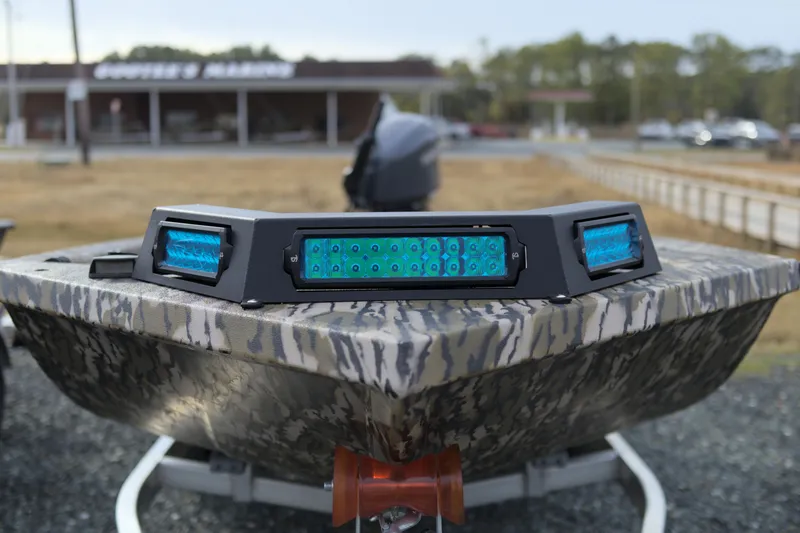 Slide: The Image of Avid 16 Commander 2026 boat with camouflage design and blue LED lights. - 10