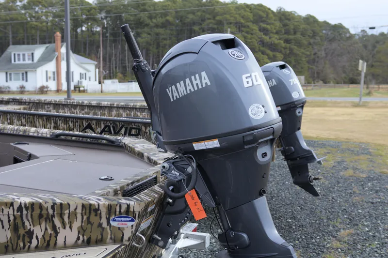 Slide: The Image of 2026 Avid 16 Commander boat with Yamaha outboard motors in a rural setting. - 3