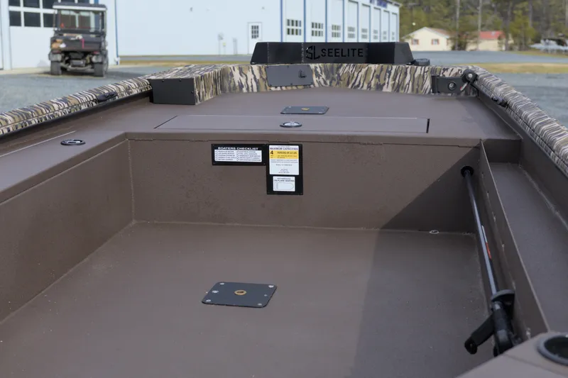 Slide: The Image of 2026 Avid 16 Commander boat interior with camouflage accents and storage compartments. - 7
