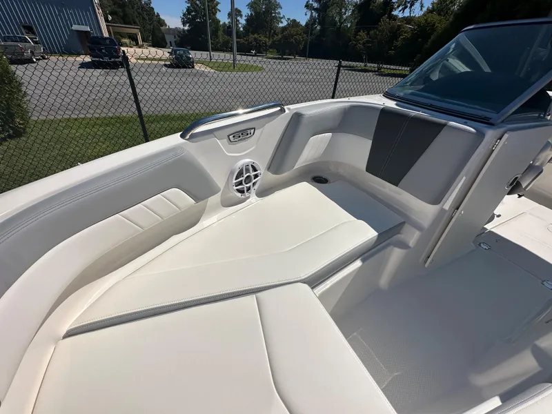 Slide: The Image of 2024 Chaparral 21 SSi OB boat interior with white seating and speaker. - 10