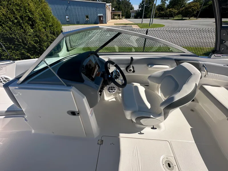 Slide: The Image of 2024 Chaparral 21 SSi OB boat interior with steering wheel and seating. - 22