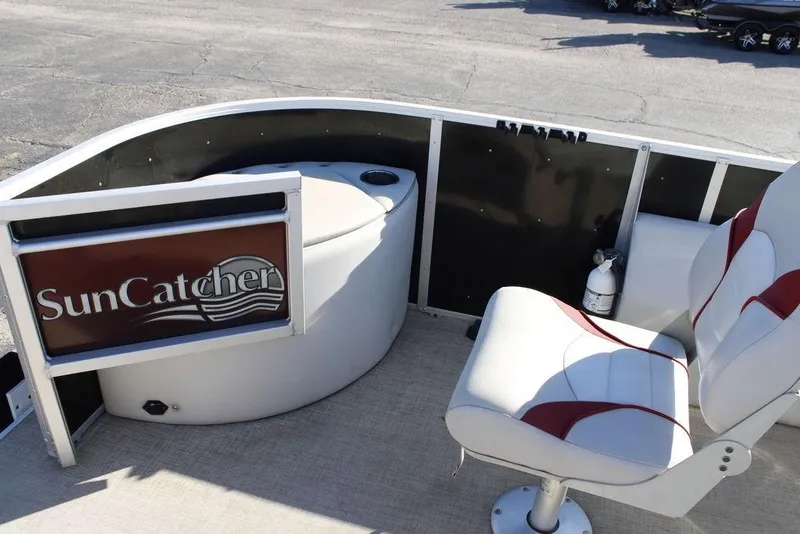 Slide: The Image of 2021 SunCatcher Select 22C boat interior with seating and SunCatcher logo. - 10