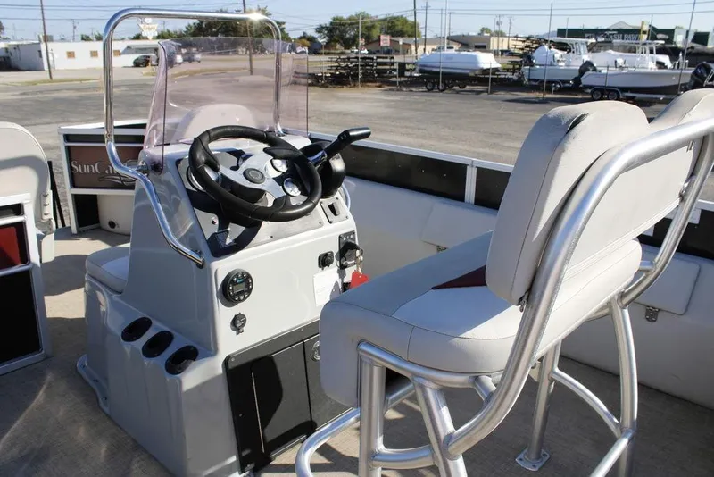 Slide: The Image of 2021 SunCatcher Select 22C boat interior with steering console and seating. - 14