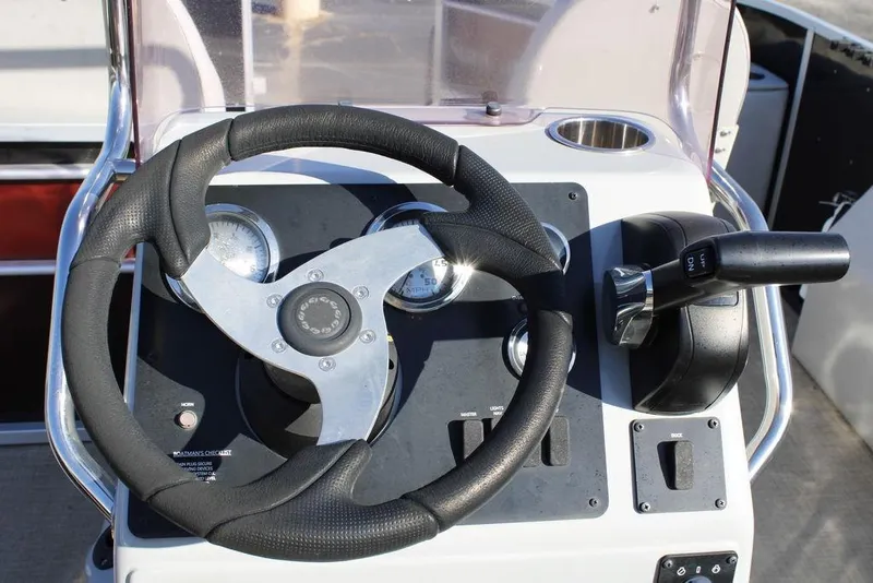 Slide: The Image of 2021 SunCatcher Select 22C boat steering console with gauges and throttle controls. - 16