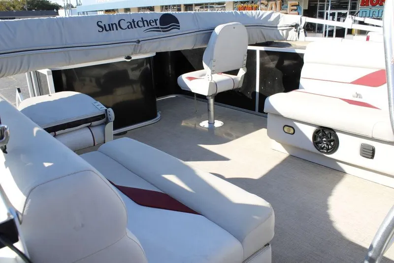 Slide: The Image of 2021 SunCatcher Select 22C pontoon boat interior with seating and helm chair. - 17