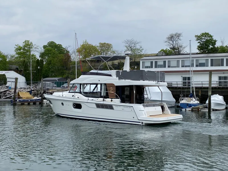 Slide: The Image of 2026 Beneteau 41 Swift Trawler FLY cruising in a marina setting. - 3