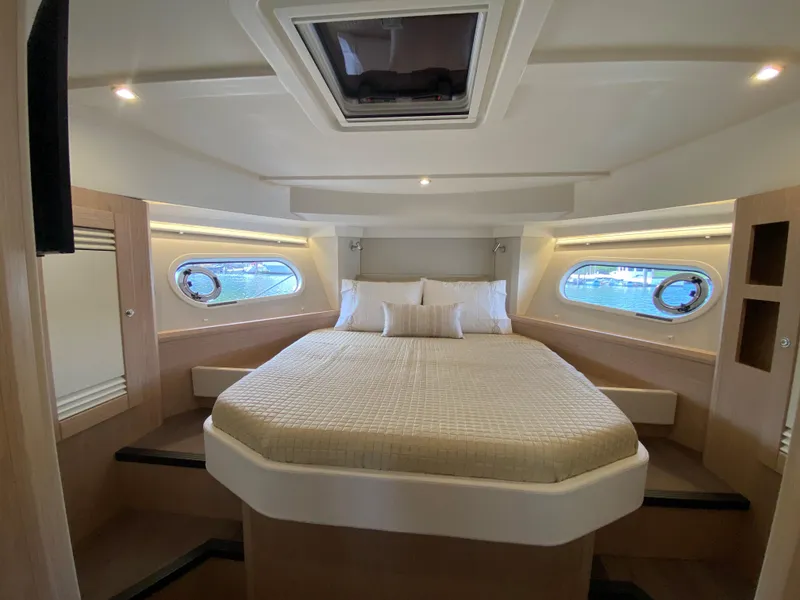 Slide: The Image of Luxurious cabin interior of 2026 Beneteau 41 Swift Trawler FLY with skylight and portholes. - 31