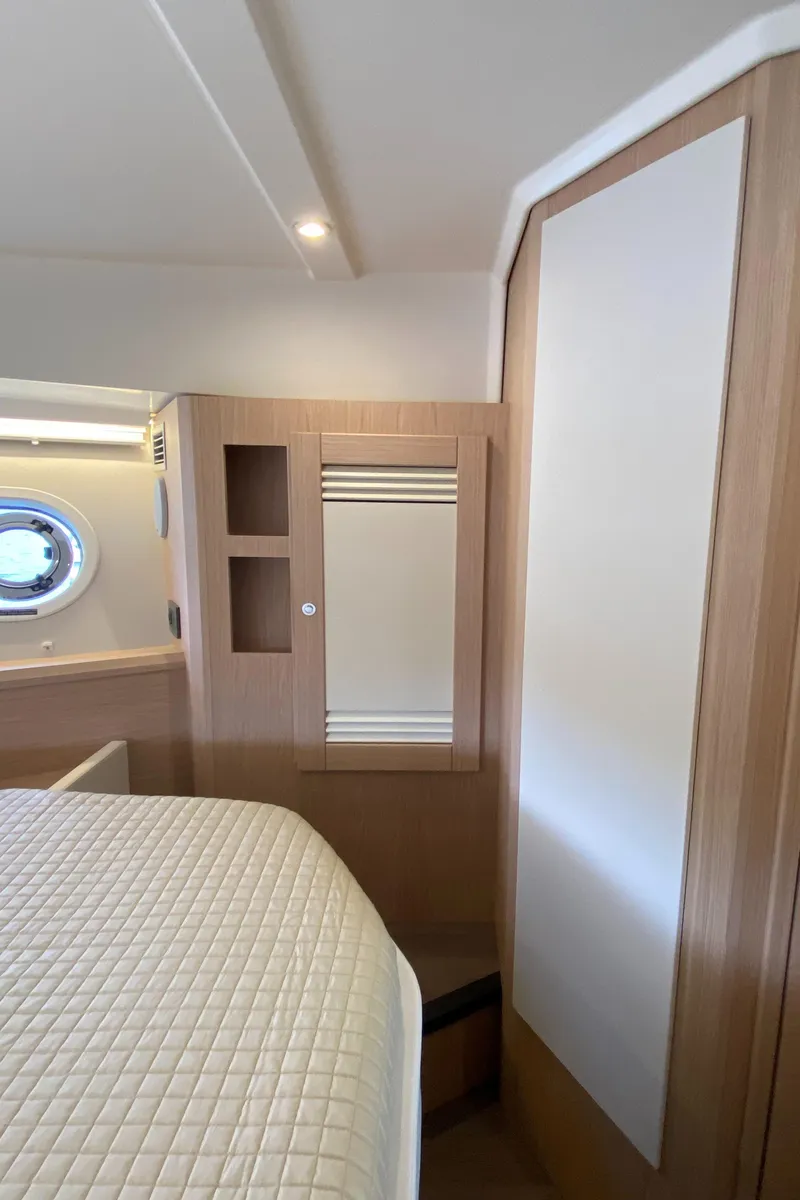 Slide: The Image of 2026 Beneteau 41 Swift Trawler FLY cabin interior with modern wood finish. - 33