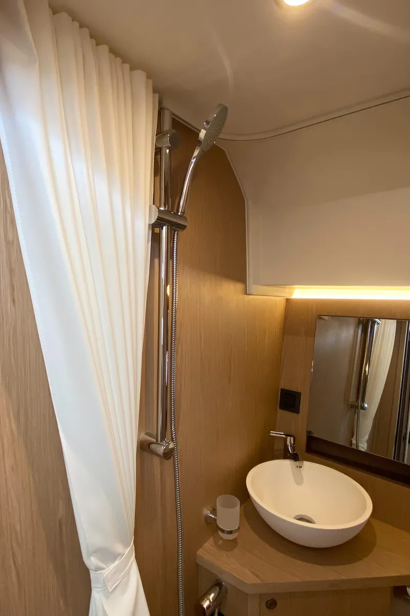 Slide: The Image of 2026 Beneteau 41 Swift Trawler FLY bathroom with modern sink and shower. - 36