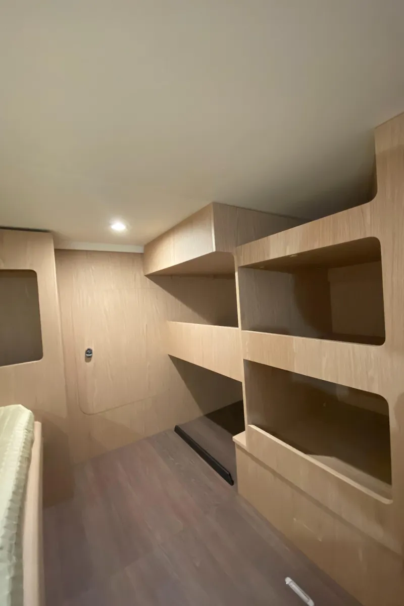 Slide: The Image of Interior of 2026 Beneteau 41 Swift Trawler FLY with modern wooden shelving. - 38