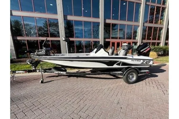 Slide: The Image of 2017 Nitro Z18 boat on trailer, parked outside modern building. - 1