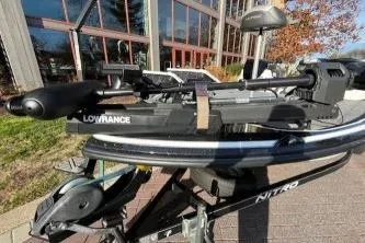 Slide: The Image of 2017 Nitro Z18 boat with Lowrance equipment, parked outdoors near a building. - 6