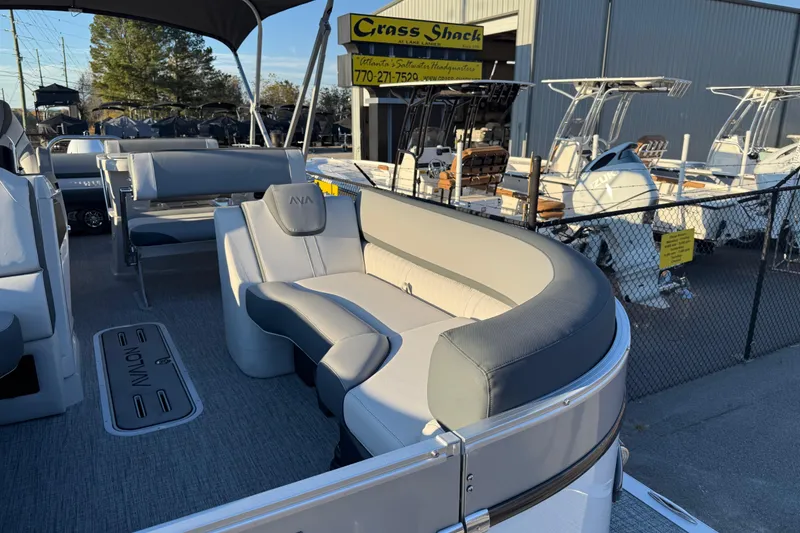 Slide: The Image of 2026 Avalon Catalina Entertainer pontoon boat with stylish seating at a dealership. - 10