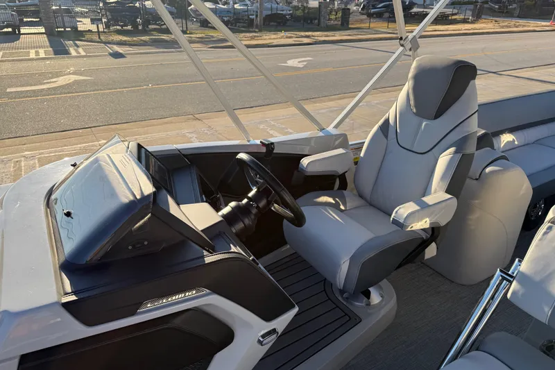 Slide: The Image of 2026 Avalon Catalina Entertainer boat interior with modern helm and comfortable captain's chair. - 14