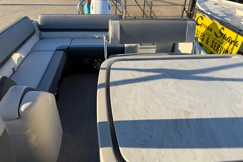 Slide: The Image of 2026 Avalon Catalina Entertainer boat interior with seating and table, docked at marina. - 18