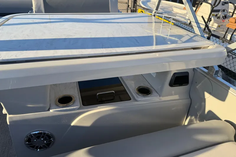 Slide: The Image of 2026 Avalon Catalina Entertainer boat interior with table and cup holders. - 21