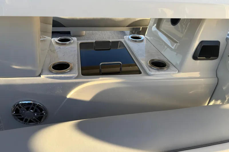 Slide: The Image of Interior of 2026 Avalon Catalina Entertainer boat with cup holders and speaker. - 22