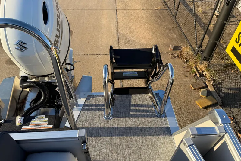 Slide: The Image of 2026 Avalon Catalina Entertainer boat with Suzuki engine and boarding ladder on dock. - 27