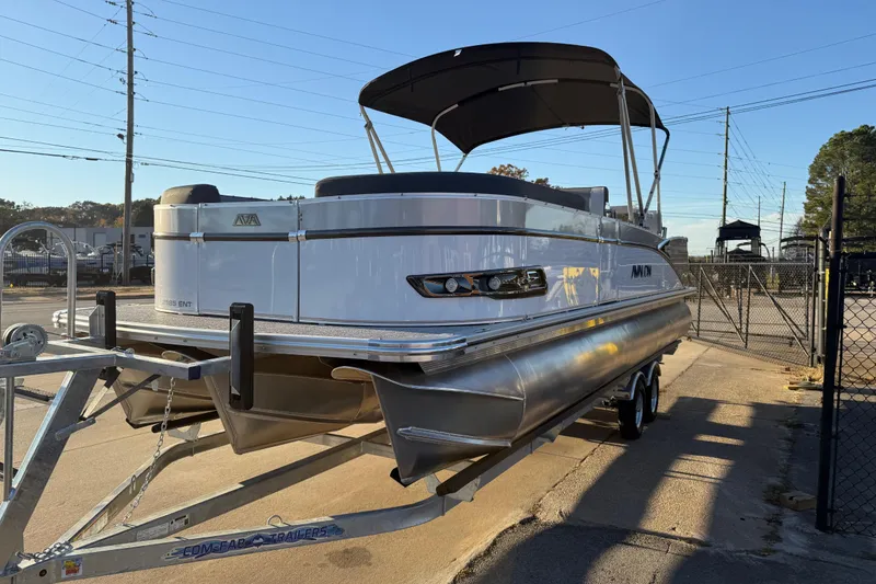 Slide: The Image of 2026 Avalon Catalina Entertainer pontoon boat on trailer, parked outdoors. - 3