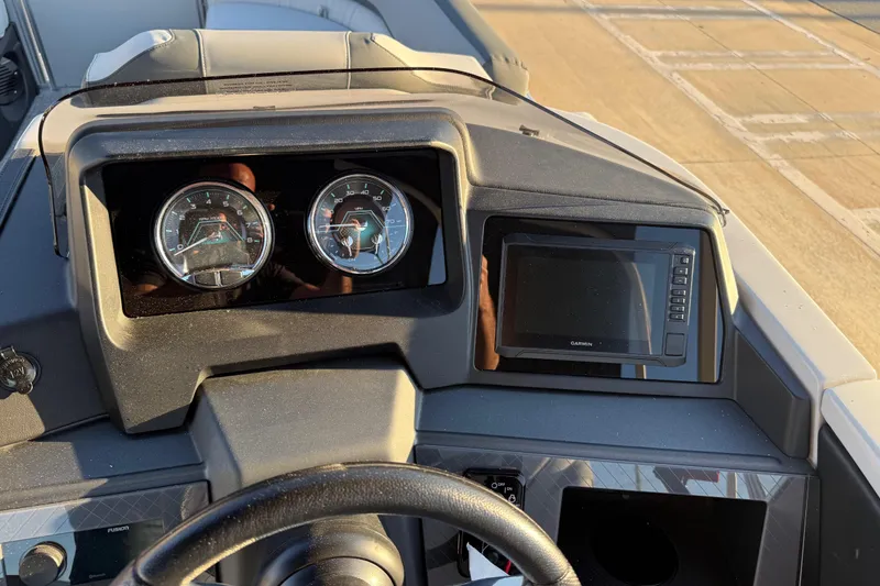 Slide: The Image of Dashboard of 2026 Avalon Catalina Entertainer boat with gauges and Garmin display. - 35
