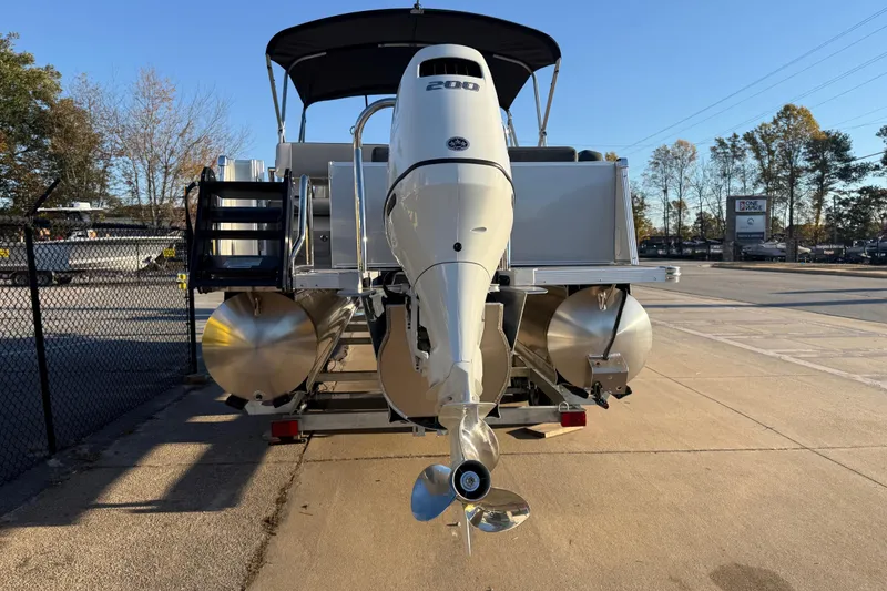 Slide: The Image of 2026 Avalon Catalina Entertainer pontoon boat with powerful outboard motor, parked outdoors. - 4