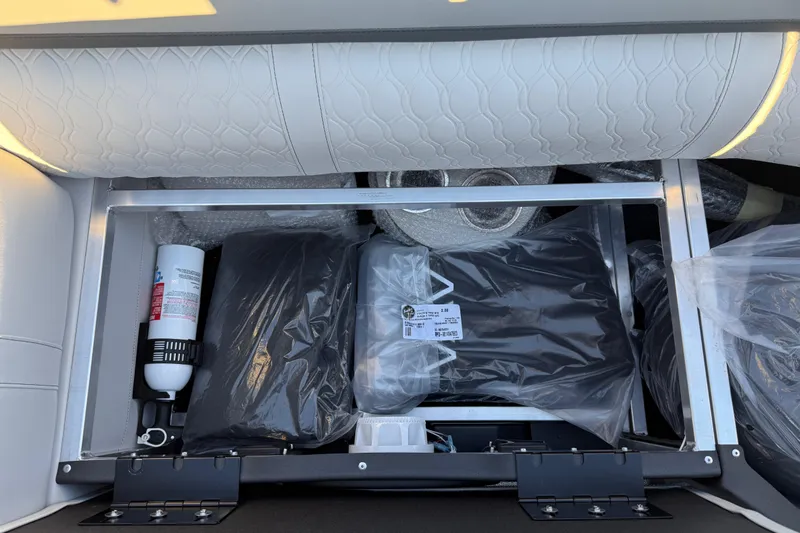 Slide: The Image of Storage compartment in 2026 Avalon Catalina Entertainer boat with safety equipment and accessories. - 49