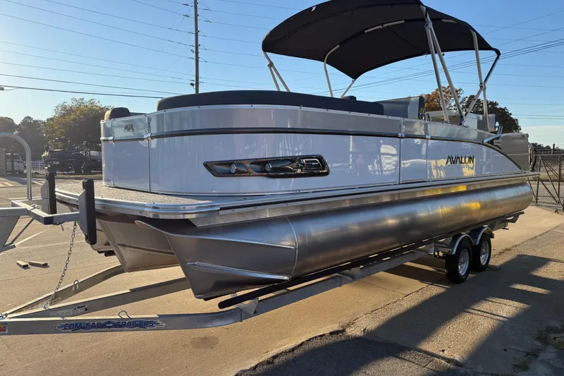 Slide: The Image of 2026 Avalon Catalina Entertainer pontoon boat on trailer, parked outdoors. - 5
