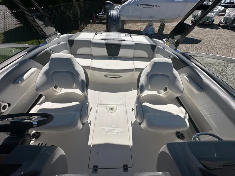 Slide: The Image of 2024 Chaparral 21 SSi OB boat interior with white seating and steering wheel. - 11