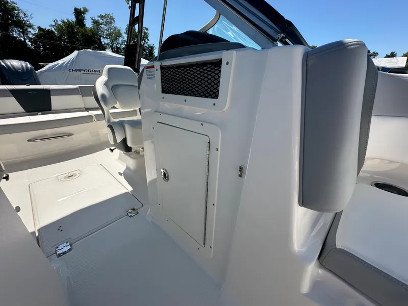 Slide: The Image of 2024 Chaparral 21 SSi OB boat interior, featuring seating and storage compartments. - 12