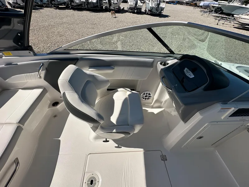 Slide: The Image of 2024 Chaparral 21 SSi OB boat interior with captain's chair and dashboard. - 19