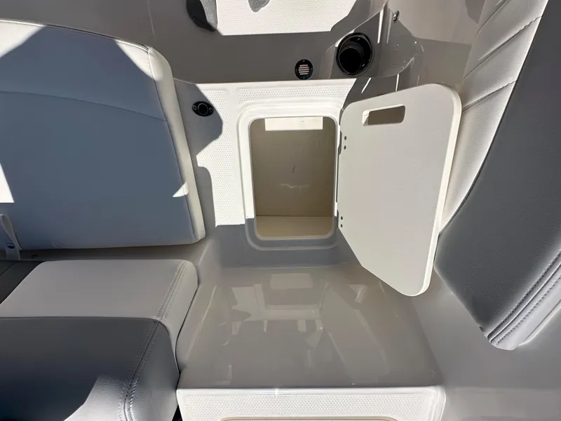 Slide: The Image of 2024 Chaparral 21 SSi OB boat interior storage compartment with open lid. - 31