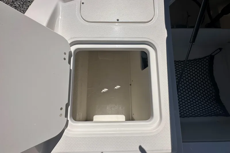 Slide: The Image of 2024 Chaparral 21 SSi OB boat storage compartment with open hatch. - 37