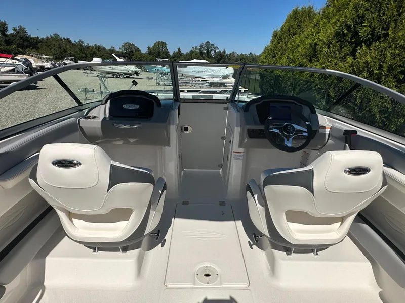 Slide: The Image of 2024 Chaparral 21 SSi OB boat interior with dual captain seats and modern dashboard. - 45