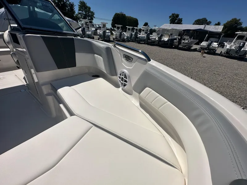 Slide: The Image of 2024 Chaparral 21 SSi OB boat interior with white seating and speaker. - 8