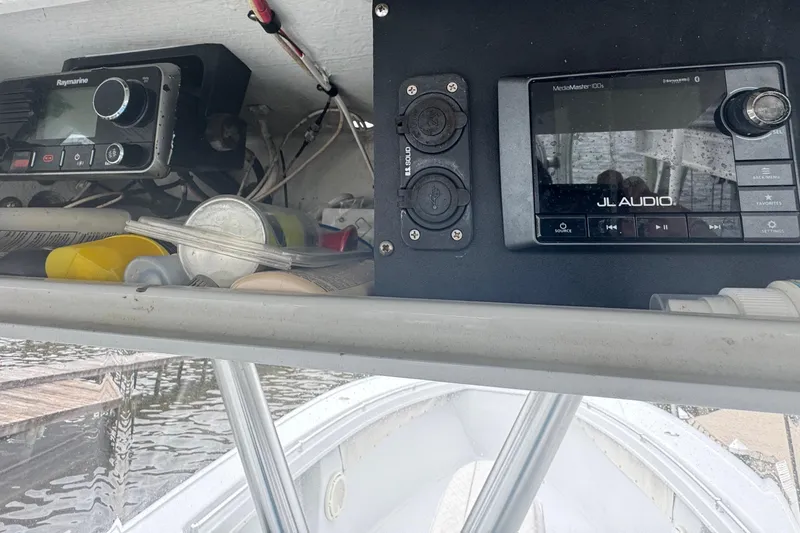 Slide: The Image of 2004 Yellowfin 36 Offshore boat with triple outboard motors on open water. - 14