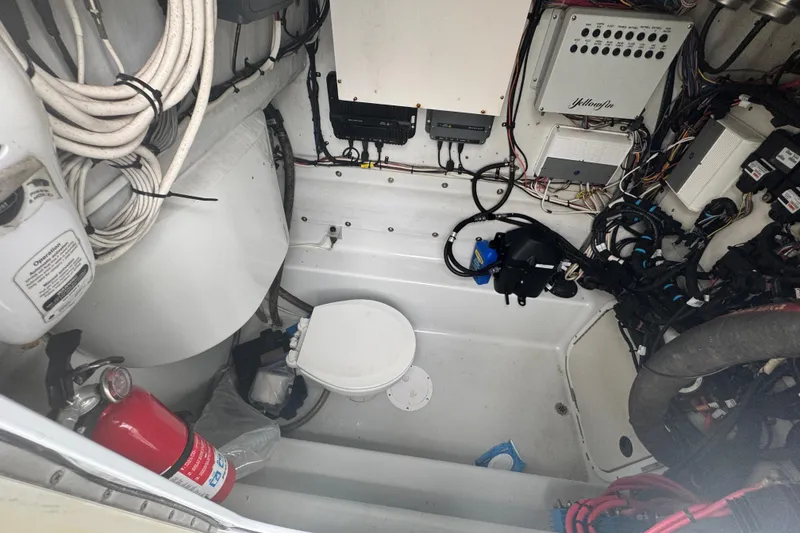 Slide: The Image of 2004 Yellowfin 36 Offshore boat on calm blue water, clear sky background. - 15