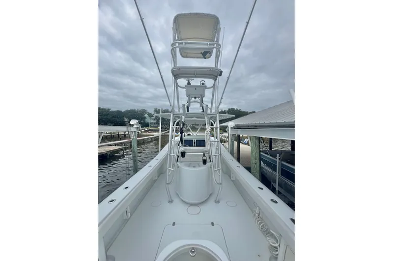 Slide: The Image of 2004 Yellowfin 36 Offshore boat docked under cloudy skies. - 19